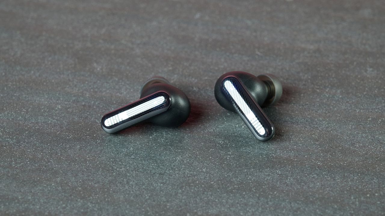 JBL Live Beam 4 earbuds on table