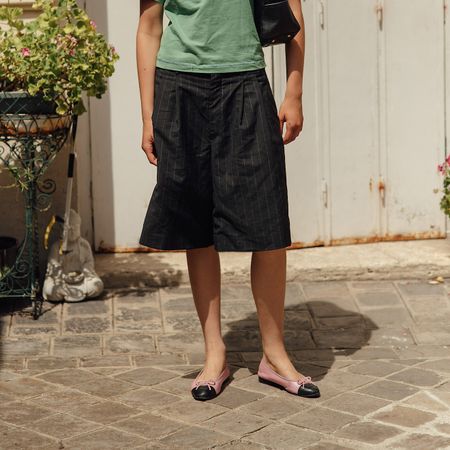 Woman wearing long taffeta shorts