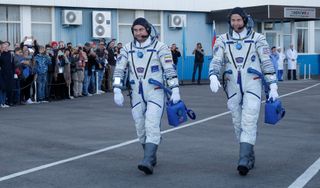 Roscosmos cosmonaut Alexey Ovchinin (left) and NASA astronaut Nick Hague, shown here en route to their Soyuz rocket for an Oct. 11, 2018, launch from Baikonur Cosmodrome, Kazakhstan, will fly again in spring. The pair's Soyuz rocket failed just after lif
