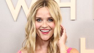 Reese Witherspooon smiling while wearing deep pink lipstick, one of the top fall makeup looks