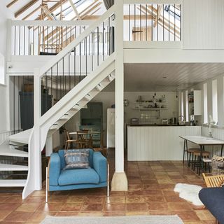 living room with white walls and stairs