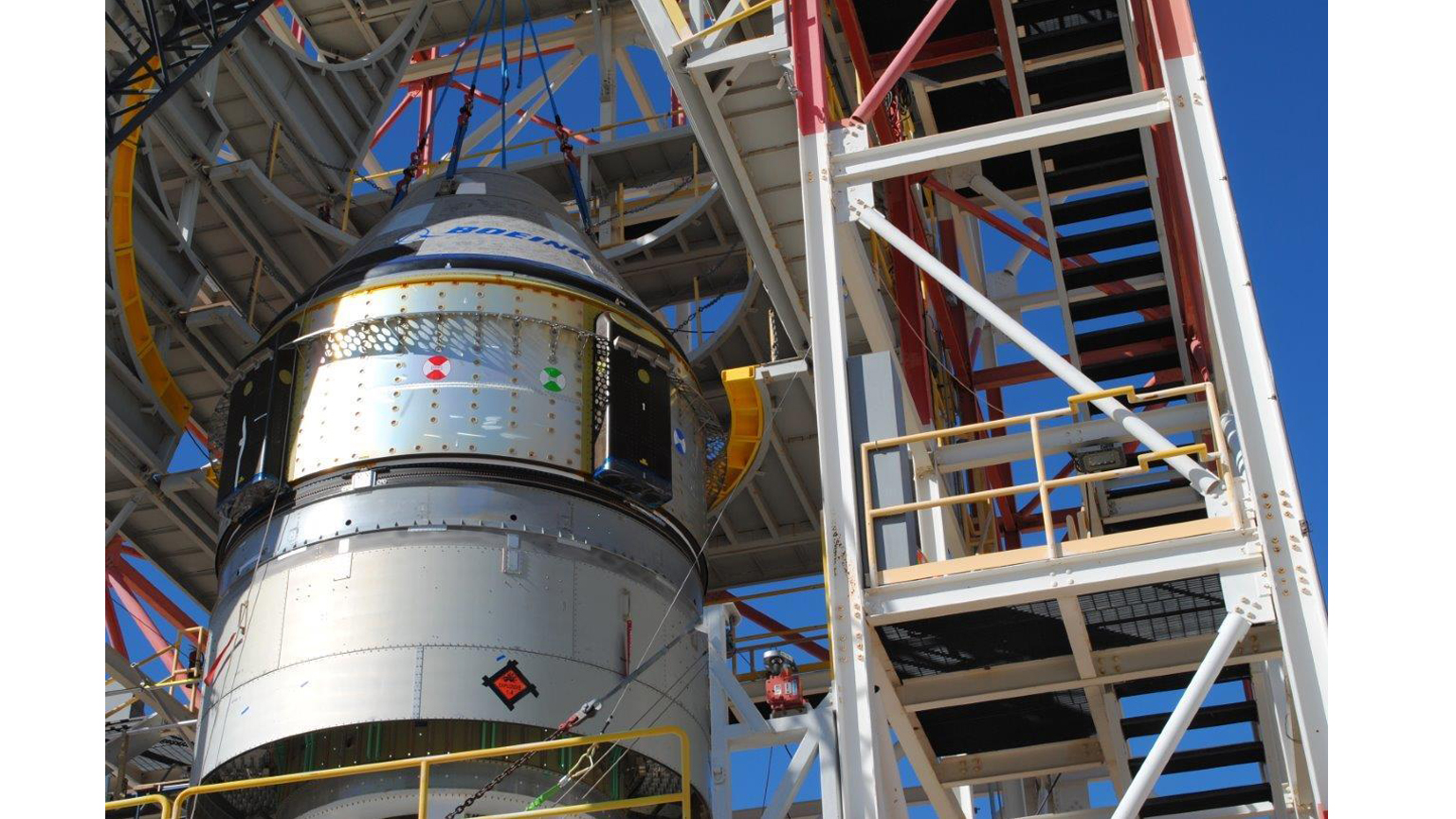 Boeing engineers prepare a CST-100 Starliner crew capsule for a critical pad abort test on Nov. 4, 2019 at the White Sands Missile Range in New Mexico. 