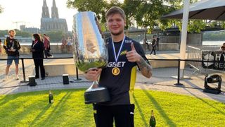 CS:GO's player of the decade s1mple holding a big cup.