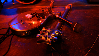 Generic view of a smashed electric guitar on a stage