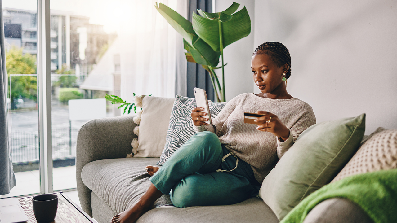 Woman on sofa using smartphone