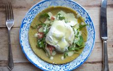 Poached eggs with tomato and rocket on a buckwheat pancake