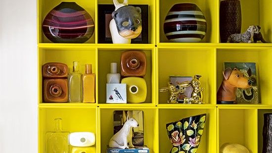 white wall with shelf on wall and bottles