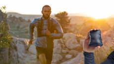 Trail runner running in the morning sun