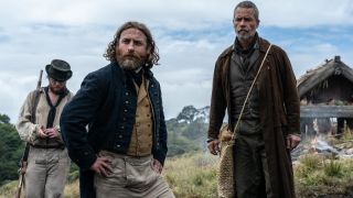 Guy Pearce stands with his co-stars on a cloudy day in The Convert.