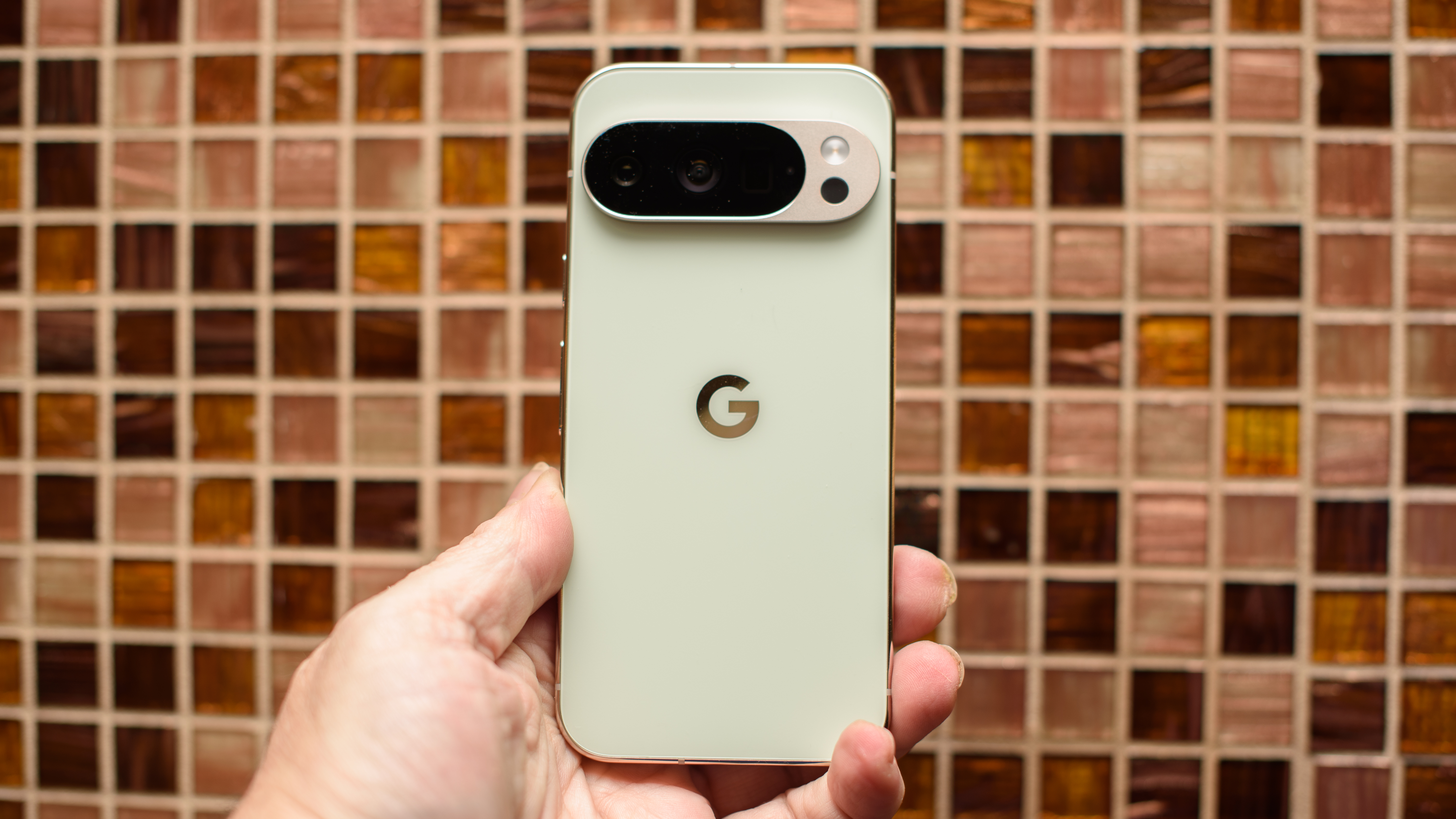 Google Pixel 10 Pro in Jade with checkered tile backsplash background