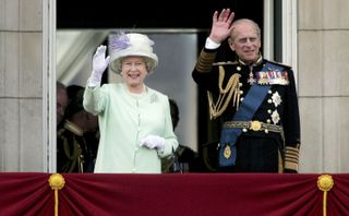 Queen Elizabeth II, The Queen, and Prince Philip, Duke of Edinburgh, watch the flypast over The Mall