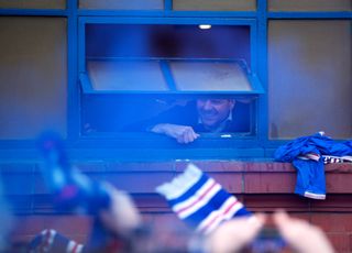 Steven Gerrard celebrates the title with fans outside Ibrox