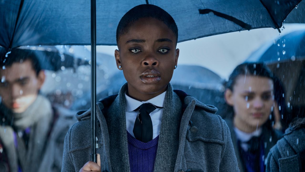 Joy Sunday as Bianca, Wednesday&#039;s rival in Netflix&#039;s &quot;Wednesday&quot; holding an umbrella in the rain