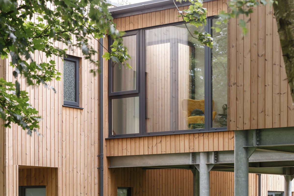 Timber cladded walls and a large window for a glazed walkway
