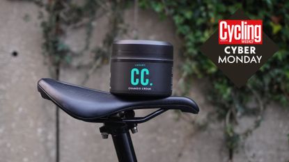 Muc-Off chamois cream on a bike saddle, with the Cycling Weekly Cyber Monday deals roundal