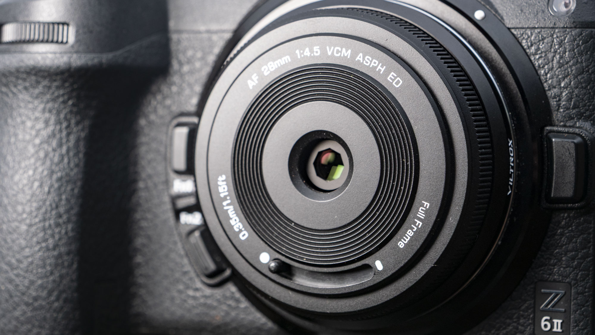 Closeup of the Viltrox AF 28mm f/4.5 body cap lens