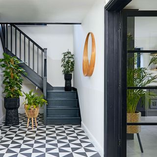 hallway with black staircase