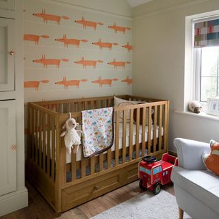 Neutral nursery with fox print wallpaper