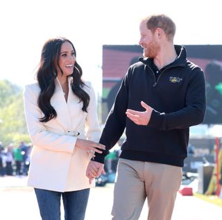 Prince Harry and Meghan Markle laughing at one another at the Invictus Games
