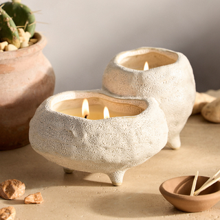 two scented candles in joined stoneware pots 