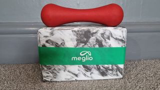 Image shows a Meglio Latex Free Resistance Band wrapped around a yoga block with a weight resting on it.
