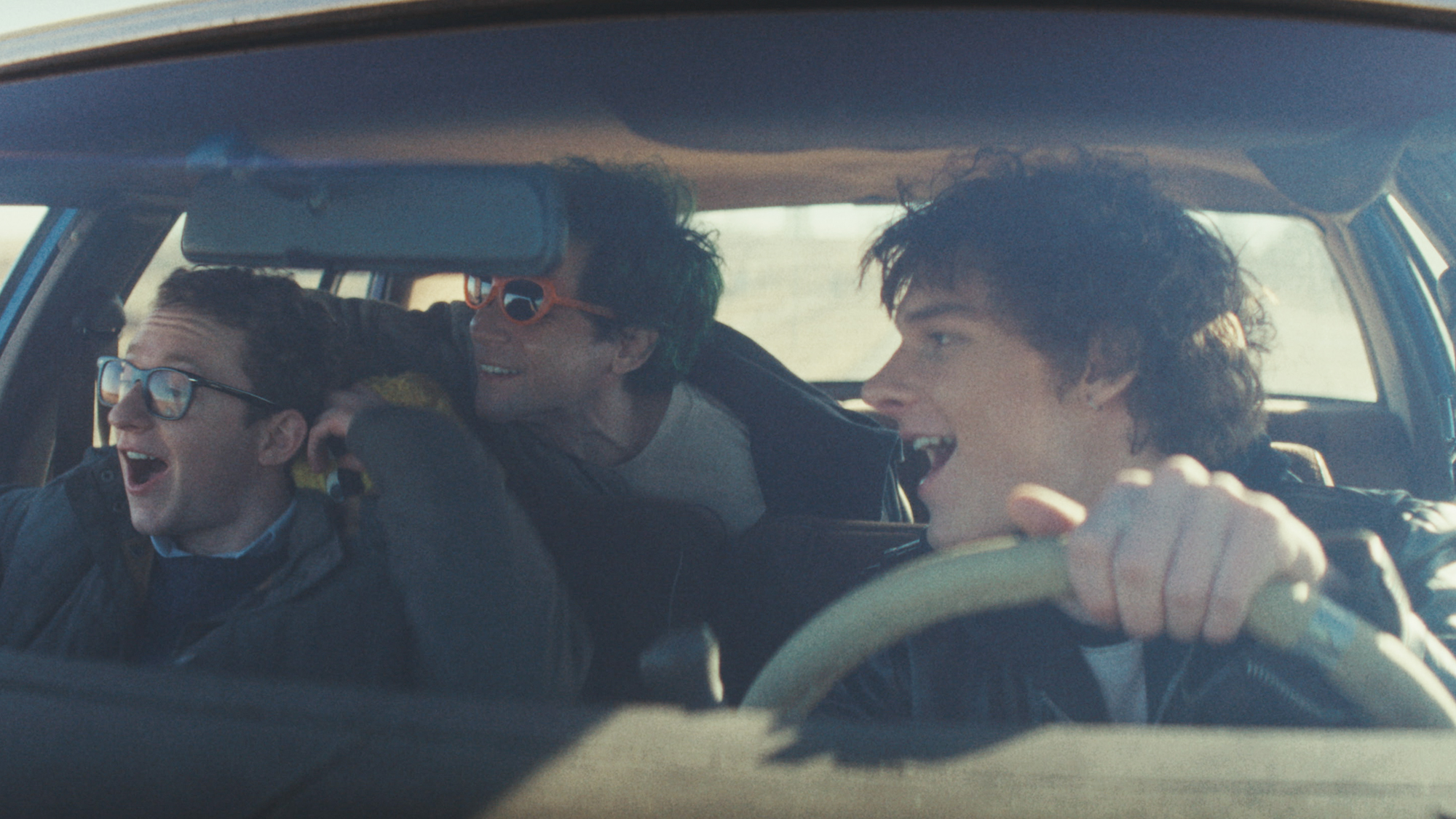 Mason Thames, Kylr Coffman, and Ryan Foust in a car on the road, all laughing and having fun in Nimrods