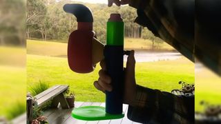 A 3D printed air raid siren, in front of some grass.