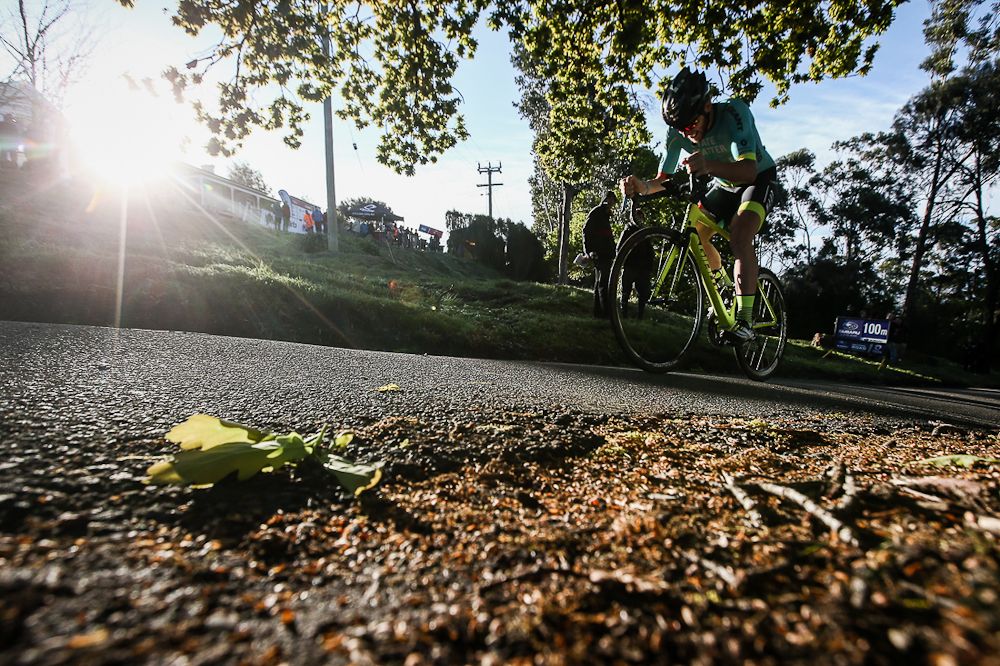 A riders climbs with the sunshine during the prologue