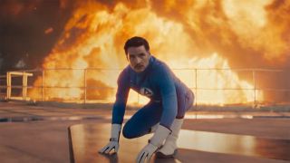 Pedro Pascal's Reed Richards in a superhero pose with an explosion going off in the background in The Fantastic Four: First Steps