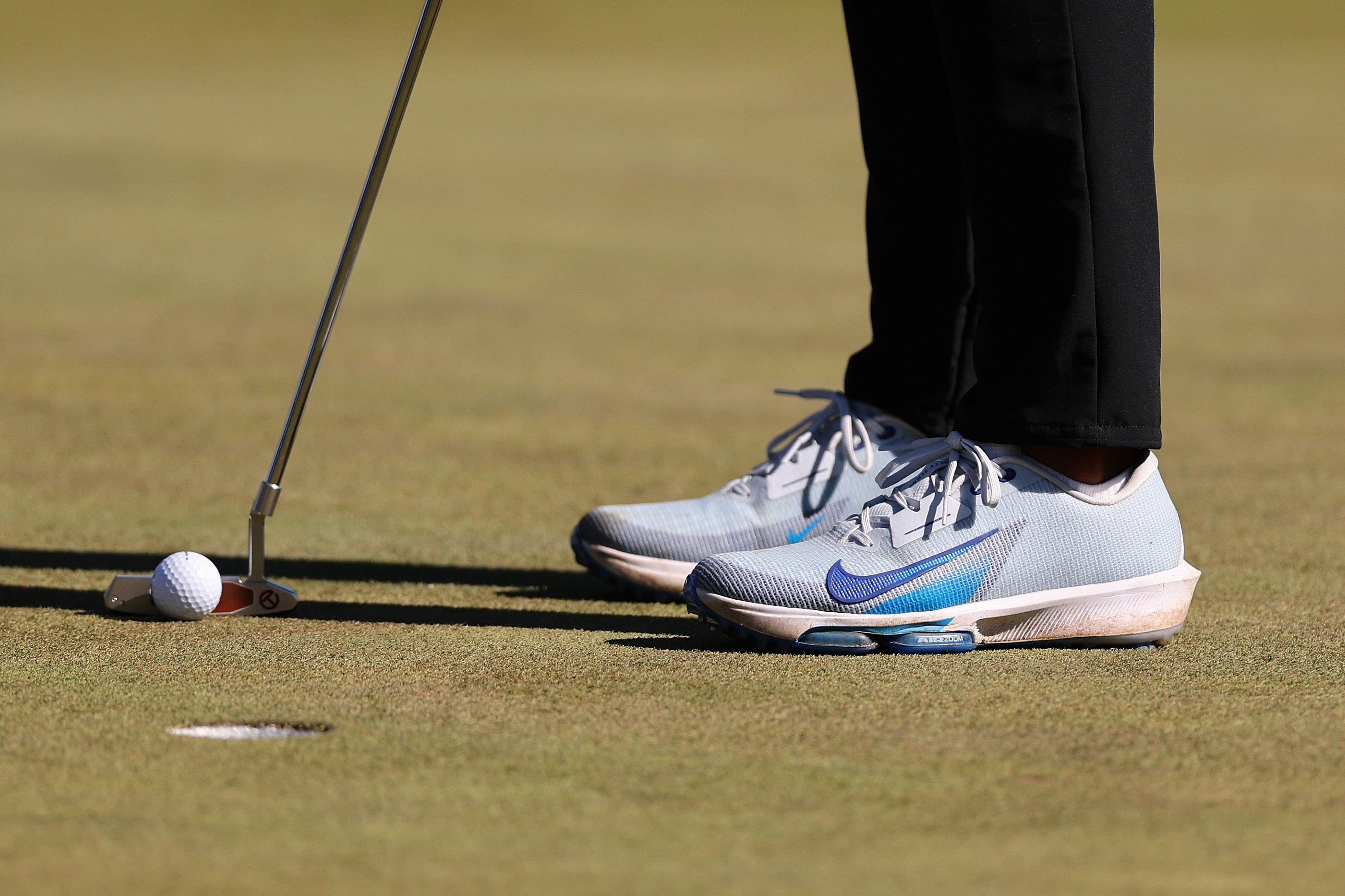 A close up of Brooks Koepka's golf shoes