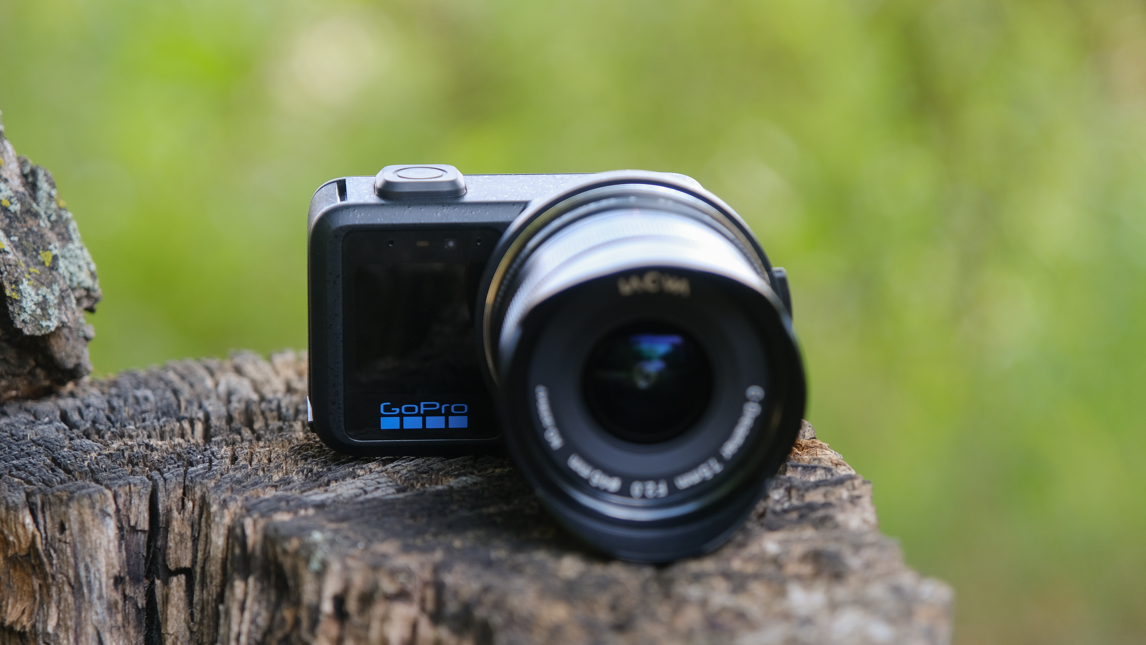 The GoPro Mission 1 ILS mirrorless camera photographed outdoors on a tree stump