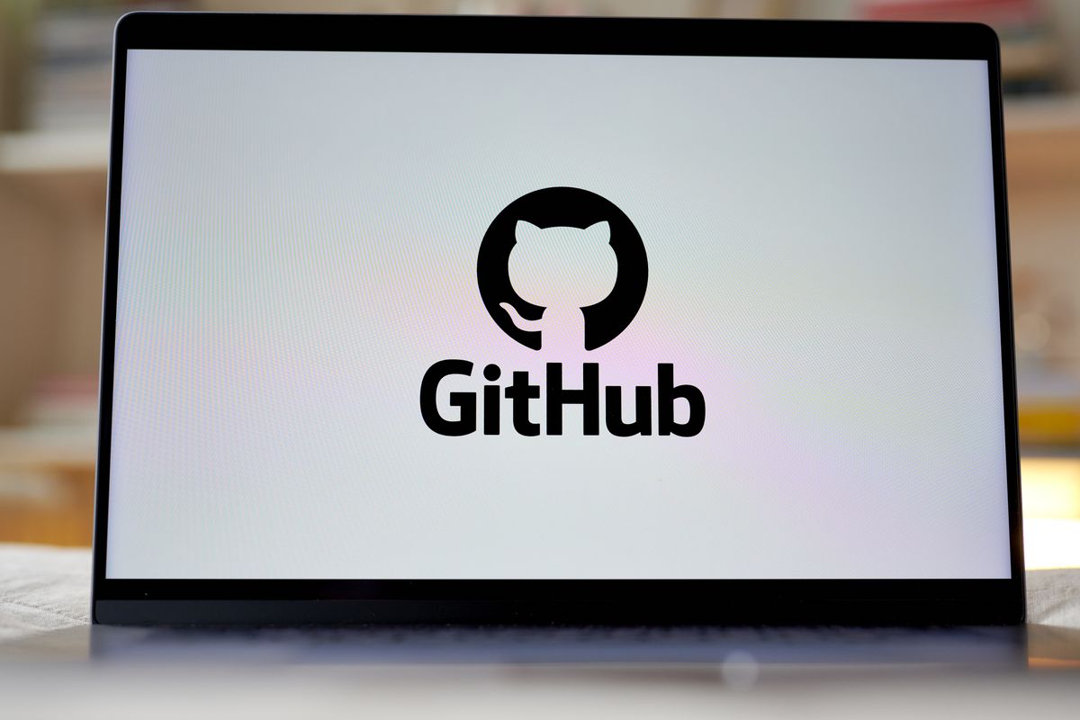 GitHub logo in black and white displayed on a laptop screen