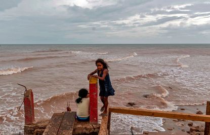 Girls play on a dock in Nicaragua as Hurricane Iota makes its way toward the country.