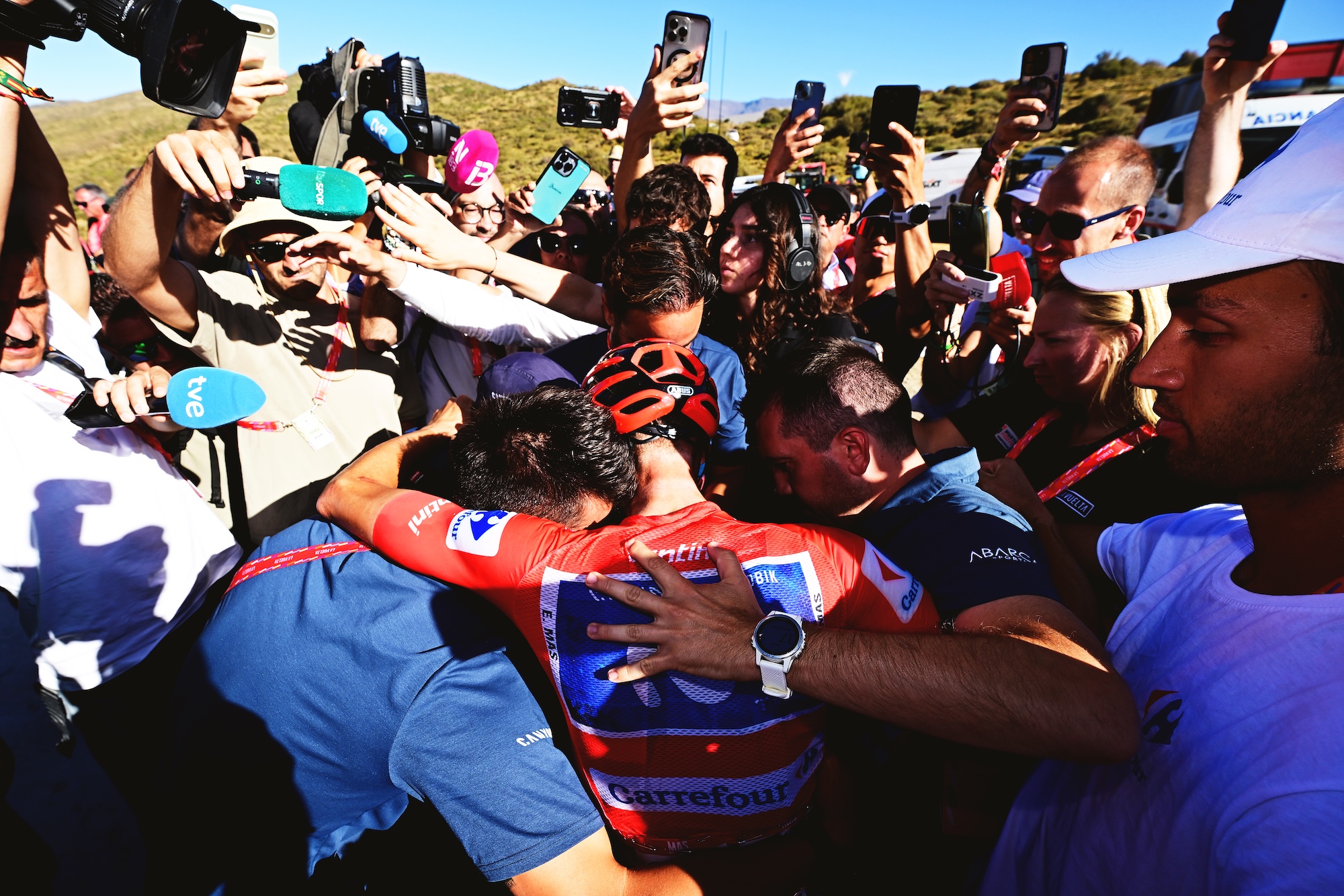 Overall final race leader Enric Mas celebrates with his team after stage 20 at the La Vuelta