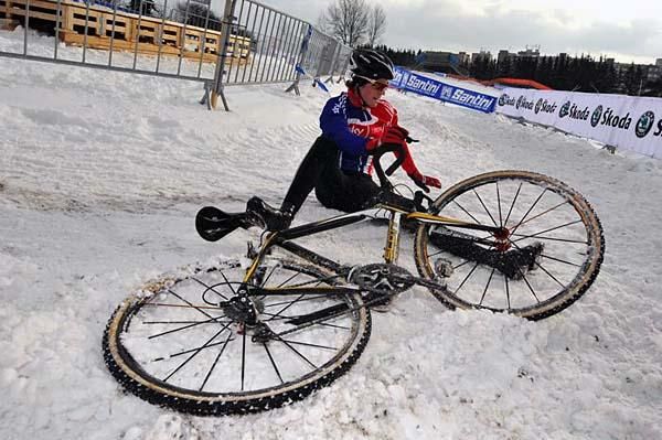 A British rider crashes on the snow and ice covered course in Tabor.