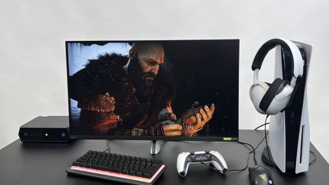 A Sony Inzone M3 gaming monitor on a table next to a PS5 and a mini PC
