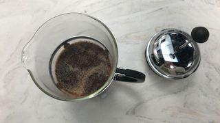 Moccamaster grinder grounds in a French press with some crema on top