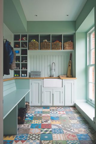 boot room with patchwork tile floor