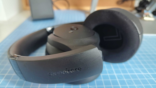 The Anker Soundcore Q20i on the writer's desk with a grid mat in his home office