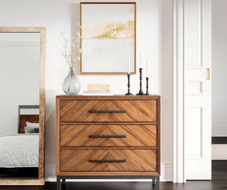 Target dresser with trinkets on top, set against a white wall.