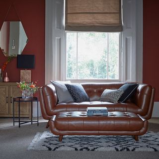 Modern retro red living room with red walls and red sofa foot stool/coffee table