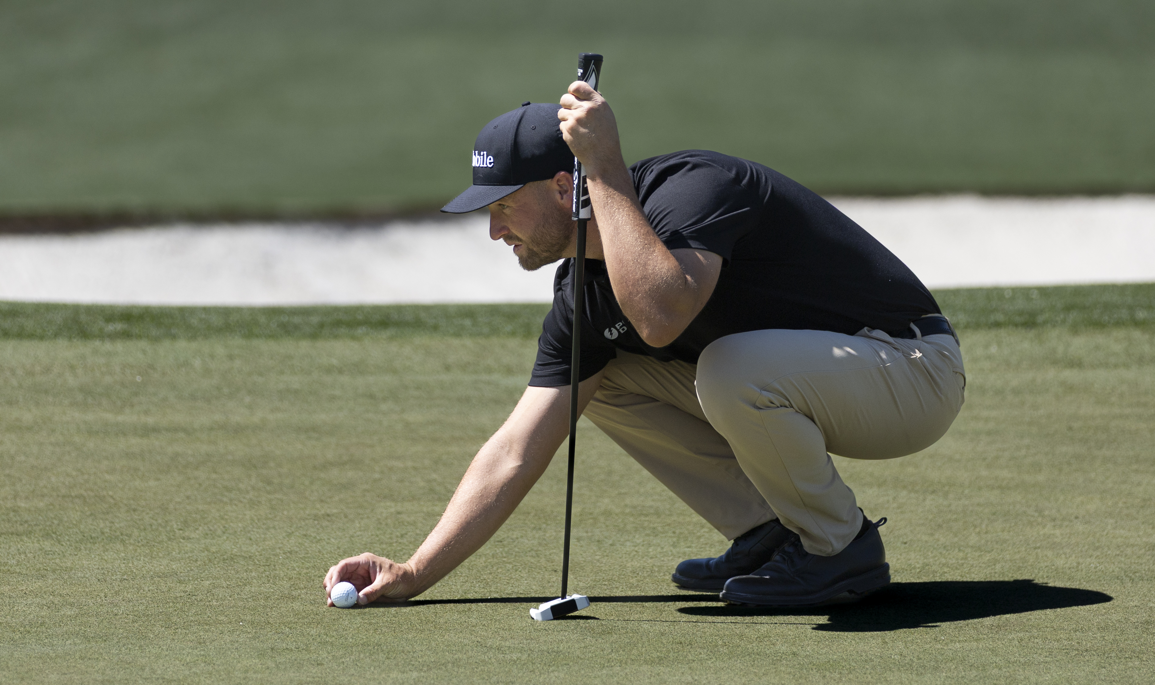 Wyndham Clark lines up a putt on the No. 2 green during a practice round prior to the Masters at Augusta National Golf Club