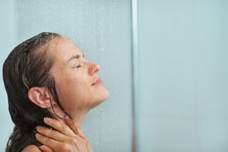 A woman with wet hair in the shower