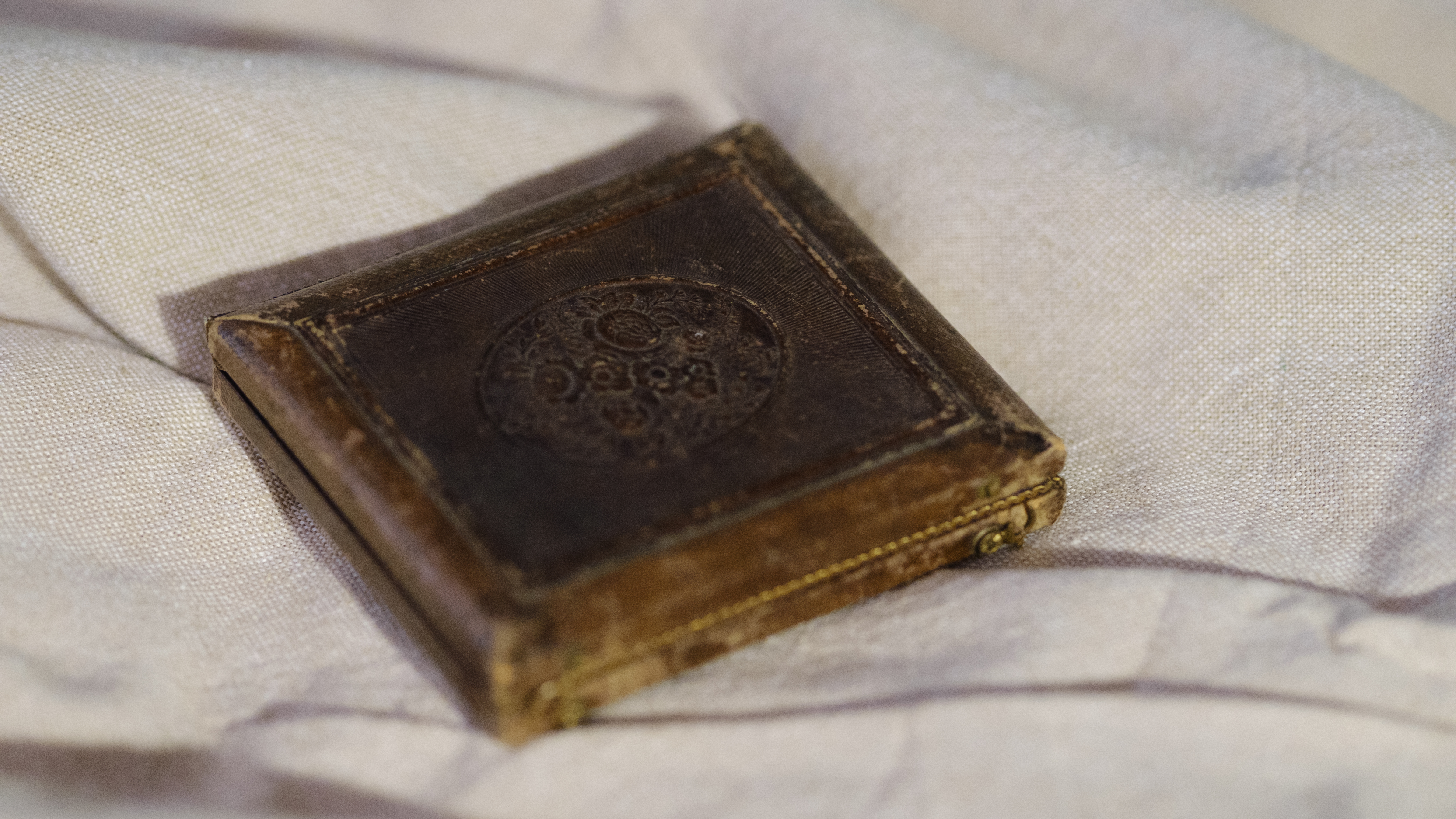 A daguerreotype on an off-white fabric background