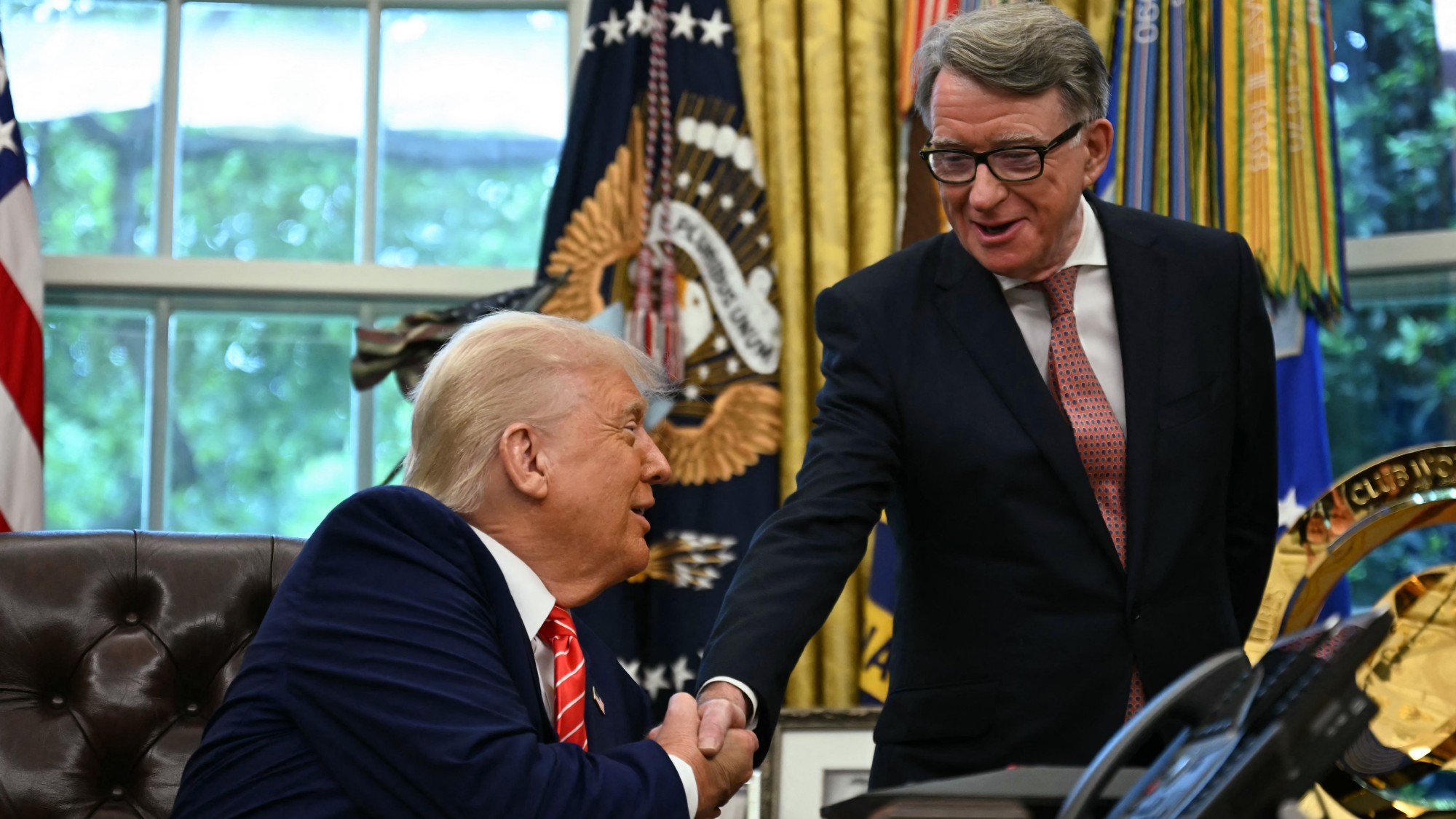 US President Donald Trump shakes hands with British ambassador to the United States Peter Mandelson in the Oval Office 