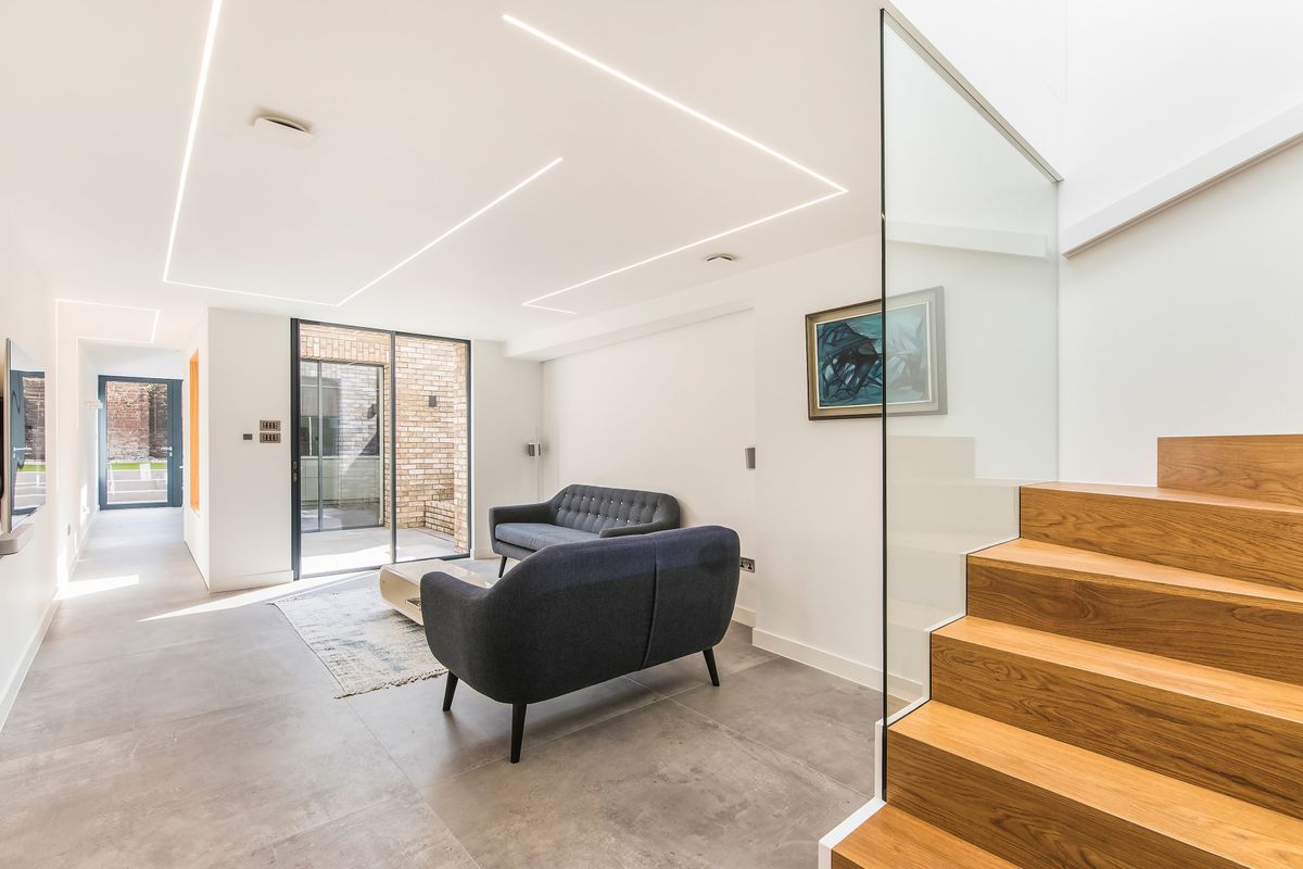 light living room with glazing and wood staircase