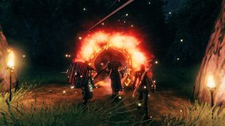 Several Valheim characters stand in front of a burning effigy