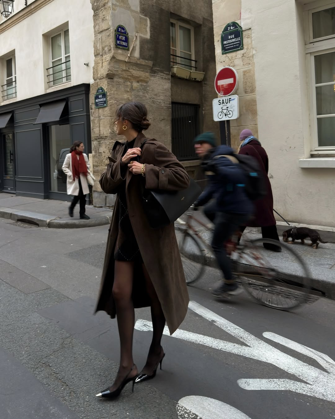 Julies Fi wears a brown trench and mini dress