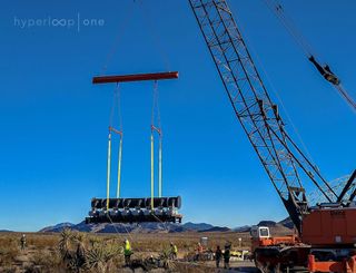 A vacuum pump is moved into position at the site of the Hyperloop One test track.