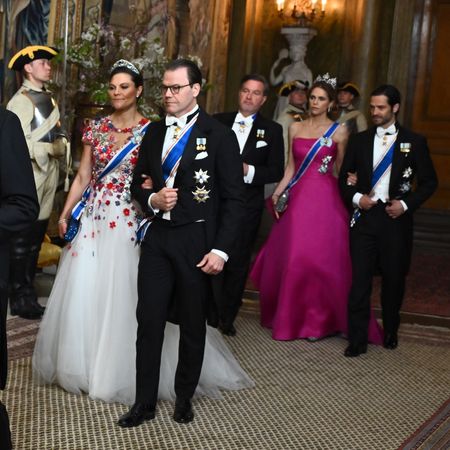 Crown Princess Victoria, Prince Daniel, Chris O'Neill, Princess Madeleine and Prince Carl Philip wearing gowns and tuxes at a state banquet